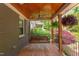 Relaxing covered porch with wood ceiling, a swing, and space for outdoor lounging at 2811 Van Dyke Ave, Raleigh, NC 27607