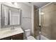 Modern bathroom featuring a glass-enclosed shower, vanity with a silver framed mirror, and a toilet at 2821 Wilshire Hill Dr # 111, Raleigh, NC 27604