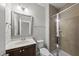 Updated bathroom featuring a glass-enclosed shower, vanity with a silver framed mirror, and ample lighting at 2821 Wilshire Hill Dr # 111, Raleigh, NC 27604