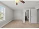 Bright bedroom with neutral walls, carpeted floor, ceiling fan, and adjacent bathroom access at 2821 Wilshire Hill Dr # 111, Raleigh, NC 27604