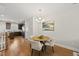 Dining area with a table and an open layout, connecting the living room and kitchen space at 2821 Wilshire Hill Dr # 111, Raleigh, NC 27604