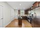 Modern kitchen featuring stainless steel appliances, dark wood cabinets, and hardwood floors at 2821 Wilshire Hill Dr # 111, Raleigh, NC 27604