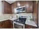 Close-up of a well-equipped kitchen featuring granite countertops, stainless steel appliances, and stylish cabinetry at 2821 Wilshire Hill Dr # 111, Raleigh, NC 27604