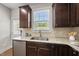 Kitchen detail showcasing granite countertops, stainless steel sink, and cabinetry with great natural light at 2821 Wilshire Hill Dr # 111, Raleigh, NC 27604