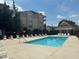 Relaxing pool area with comfortable lounge chairs and nearby condo buildings at 2821 Wilshire Hill Dr # 111, Raleigh, NC 27604