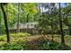 Back exterior with a large deck, surrounded by towering trees offering a tranquil and secluded retreat at 2901 Horse Shoe Farm Rd, Wake Forest, NC 27587