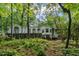 Home exterior featuring a deck with lattice and green foliage in a private, wooded backyard at 2901 Horse Shoe Farm Rd, Wake Forest, NC 27587