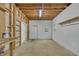 Large basement area with door, window, wood beams, shelving and concrete floor at 2901 Horse Shoe Farm Rd, Wake Forest, NC 27587
