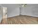 Bright bedroom with neutral walls, wood floors, and an open doorway to other rooms at 2901 Horse Shoe Farm Rd, Wake Forest, NC 27587