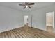 Spacious main bedroom with wood flooring, ceiling fan, and an en suite bathroom at 2901 Horse Shoe Farm Rd, Wake Forest, NC 27587