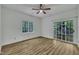 Bright bedroom with hardwood floors, ceiling fan, large window, and sliding glass door to outside at 2901 Horse Shoe Farm Rd, Wake Forest, NC 27587