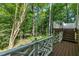 Wooden deck featuring white latticework railing and wooded backyard views at 2901 Horse Shoe Farm Rd, Wake Forest, NC 27587