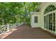 Wooden deck featuring white latticework railing and wooded backyard views at 2901 Horse Shoe Farm Rd, Wake Forest, NC 27587