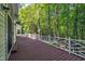 Wooden deck featuring white latticework railing and wooded backyard views at 2901 Horse Shoe Farm Rd, Wake Forest, NC 27587