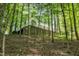 View of the home's exterior with a large deck, surrounded by dense trees and greenery at 2901 Horse Shoe Farm Rd, Wake Forest, NC 27587