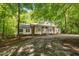 Charming brick and white home nestled among trees with a circular driveway at 2901 Horse Shoe Farm Rd, Wake Forest, NC 27587