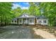 Beautiful brick and white home surrounded by lush greenery at 2901 Horse Shoe Farm Rd, Wake Forest, NC 27587
