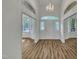 Bright foyer with hardwood floors, chandelier, and stained glass transom at 2901 Horse Shoe Farm Rd, Wake Forest, NC 27587