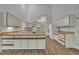 Well-lit kitchen featuring white cabinets, wood countertops, and hardwood floors, providing a clean and functional cooking space at 2901 Horse Shoe Farm Rd, Wake Forest, NC 27587