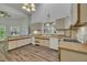 Bright kitchen featuring modern appliances, wood floors, light countertops, and unique lighting fixtures at 2901 Horse Shoe Farm Rd, Wake Forest, NC 27587