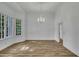 Open concept living room with wood floors, large windows, and modern lighting at 2901 Horse Shoe Farm Rd, Wake Forest, NC 27587