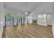 Open living room with hardwood floors, a brick fireplace, and french doors, creating a bright and airy space at 2901 Horse Shoe Farm Rd, Wake Forest, NC 27587