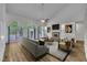 Bright living room featuring a fireplace, hardwood floors, and abundant natural light from the large french doors at 2901 Horse Shoe Farm Rd, Wake Forest, NC 27587