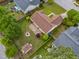 Aerial view of the backyard with a fire pit, storage shed, and lush greenery at 308 Holly Briar Dr, Fuquay Varina, NC 27526