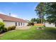 Spacious backyard with patio area, green lawn, and mature trees at 308 Holly Briar Dr, Fuquay Varina, NC 27526