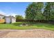 Expansive backyard with a brick patio, fire pit, storage shed, and mature trees for privacy at 308 Holly Briar Dr, Fuquay Varina, NC 27526