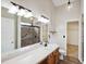 Bright bathroom with double vanity, modern fixtures, and a glass-enclosed shower at 308 Holly Briar Dr, Fuquay Varina, NC 27526