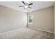 Bedroom features neutral carpet, ceiling fan and a window providing natural light at 308 Holly Briar Dr, Fuquay Varina, NC 27526