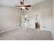 Spacious bedroom with neutral walls and carpet, ceiling fan, and easy access to the bathroom at 308 Holly Briar Dr, Fuquay Varina, NC 27526