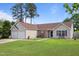 Inviting front exterior with a two-car garage, manicured lawn, and stylish stone and siding facade at 308 Holly Briar Dr, Fuquay Varina, NC 27526