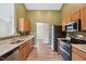 Functional kitchen featuring stainless steel appliances, granite counters, and wood-look floors at 308 Holly Briar Dr, Fuquay Varina, NC 27526