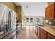 Well-lit kitchen with granite countertops, stainless steel appliances, and access to the backyard at 308 Holly Briar Dr, Fuquay Varina, NC 27526