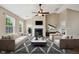 Bright living room featuring high ceilings, a fireplace, neutral paint, and a ceiling fan at 308 Holly Briar Dr, Fuquay Varina, NC 27526