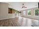 Open living room with a ceiling fan, natural light, and wood-look floors at 308 Holly Briar Dr, Fuquay Varina, NC 27526