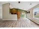 Open-concept living space with updated flooring and natural light from large windows at 308 Holly Briar Dr, Fuquay Varina, NC 27526
