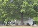 View of the community pool house amenities with a lush green background with mature trees at 308 Holly Briar Dr, Fuquay Varina, NC 27526