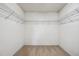 Spacious walk-in closet featuring metal shelving and carpeted floor at 308 Holly Briar Dr, Fuquay Varina, NC 27526