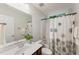Cozy bathroom featuring a tiled shower/tub, a vanity sink, a decorative shower curtain, and a large mirror at 315 Copper Ridge Dr, Sanford, NC 27330