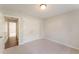 Carpeted bedroom features neutral walls, a closet, and an open doorway with views into the hallway at 315 Copper Ridge Dr, Sanford, NC 27330