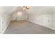 A bonus room with neutral walls and carpet features a ceiling fan, and a staircase at 315 Copper Ridge Dr, Sanford, NC 27330
