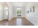Bright dining room with hardwood floors, an arched window, and wainscoting for an elegant look at 315 Copper Ridge Dr, Sanford, NC 27330
