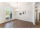 Bright dining room with hardwood floors, arched window and chair rail, offering elegant entertaining space at 315 Copper Ridge Dr, Sanford, NC 27330