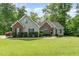Charming single-Gathering home with brick and siding, surrounded by a lush green lawn and mature trees at 315 Copper Ridge Dr, Sanford, NC 27330