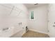 Practical laundry room featuring tile floors, a sink, and wire shelving for easy organization at 315 Copper Ridge Dr, Sanford, NC 27330