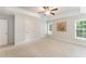 Spacious main bedroom features a ceiling fan, a tray ceiling, and multiple windows for natural light at 315 Copper Ridge Dr, Sanford, NC 27330