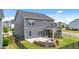 Aerial view of backyard with patio, screened-in porch and stone fire pit feature at 316 Barley Mill Rd, Holly Springs, NC 27540
